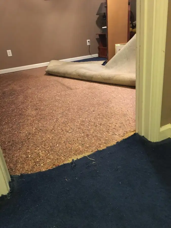 Carpet pad removal revealing water damage during Drying & Dehumidification in Salinas